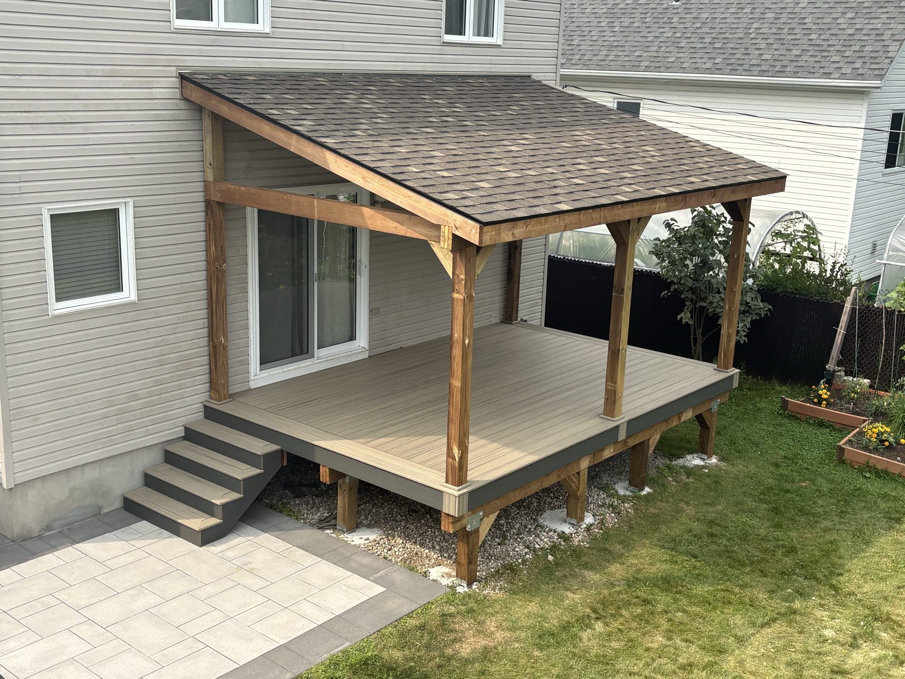 Post and beam covered porch roof over a composite deck
