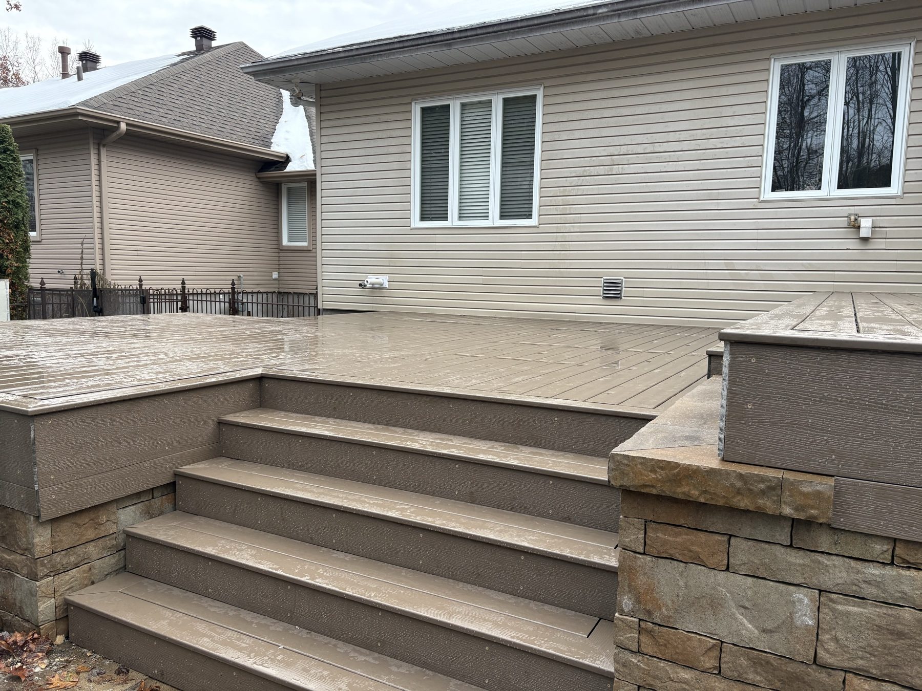 Wide composite stairs with stone veneer skirting
